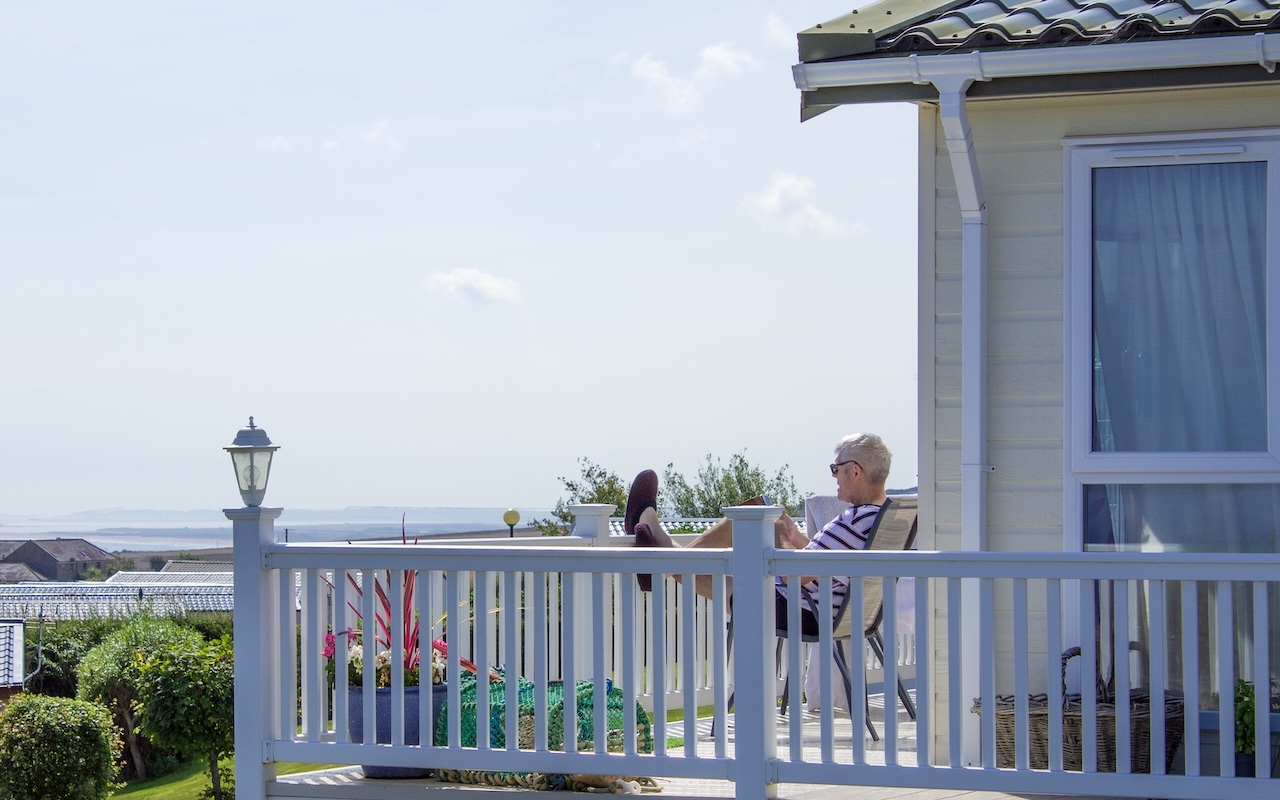 Man relaxing on porch of holiday home